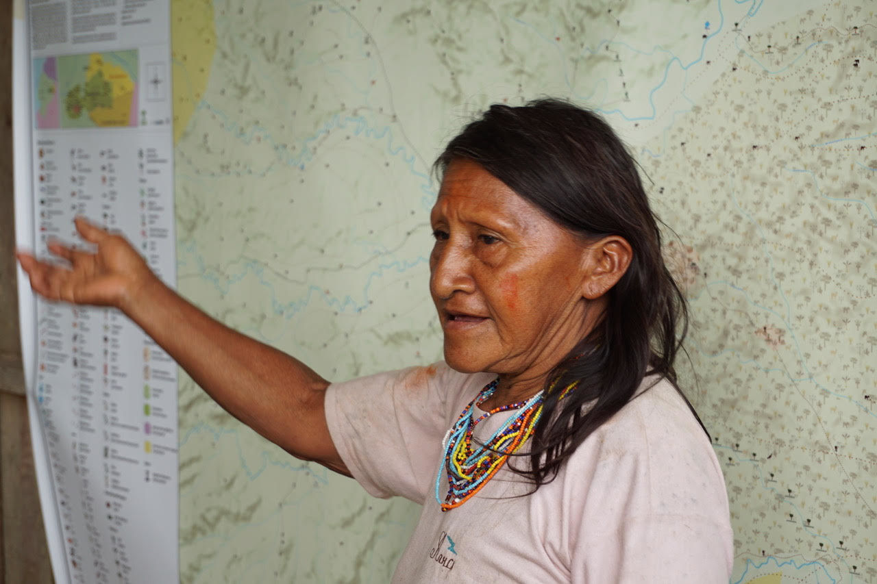 Waorani woman explains map