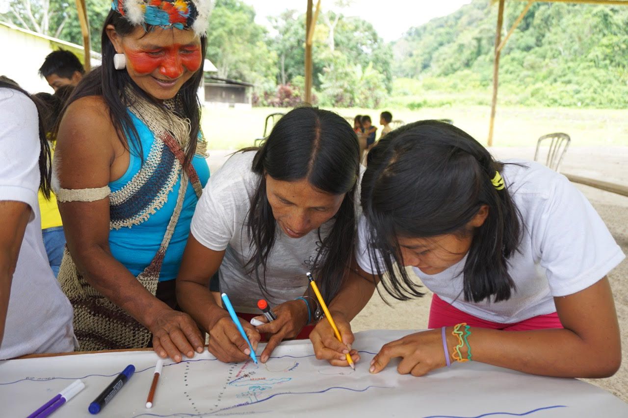 Waorani women drawing map